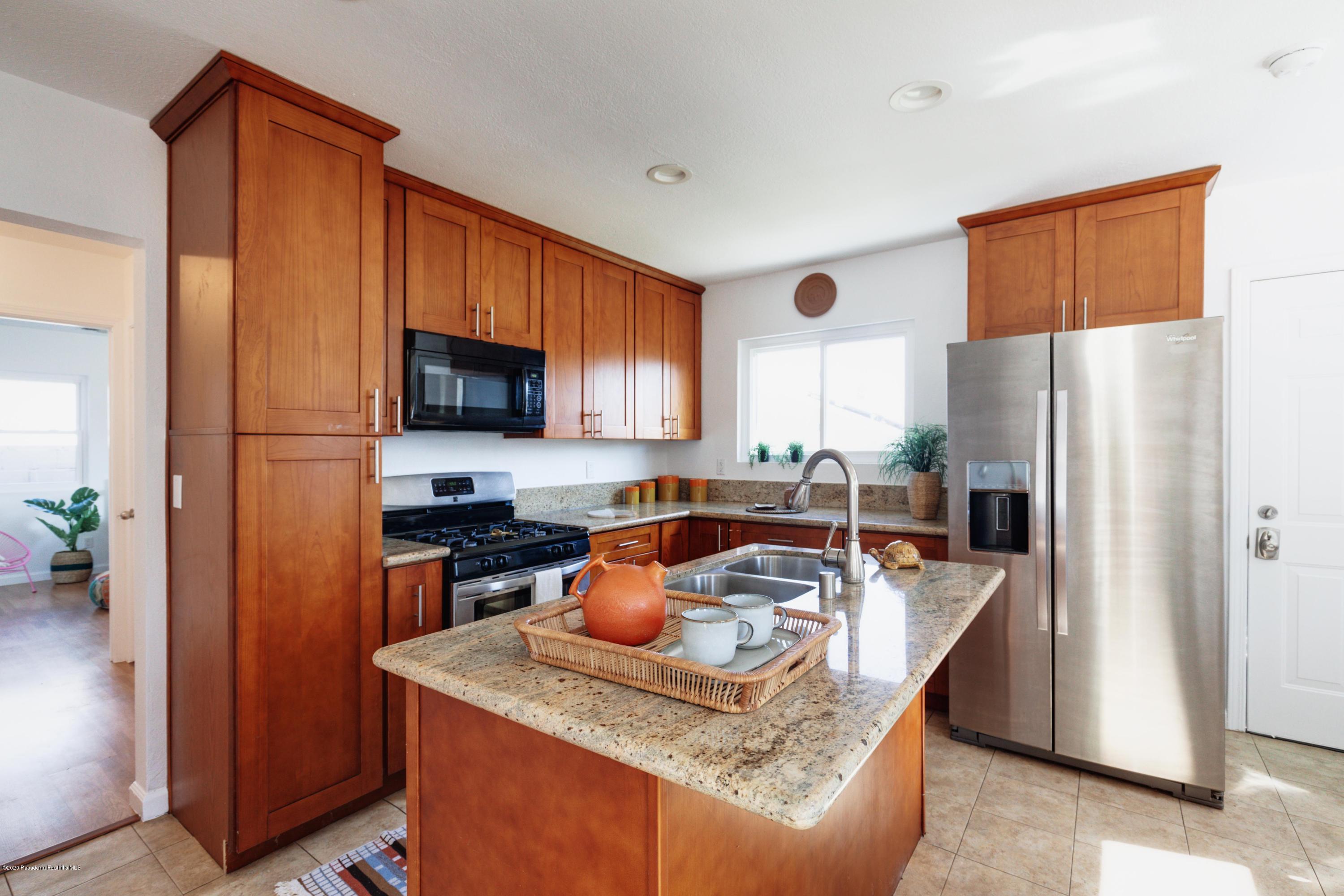 58 Mountain View Street Altadena, CA 91001 - Photo 7 of 30 a kitchen with stainless steel appliances granite countertop a refrigerator a stove top oven a sink and dishwasher