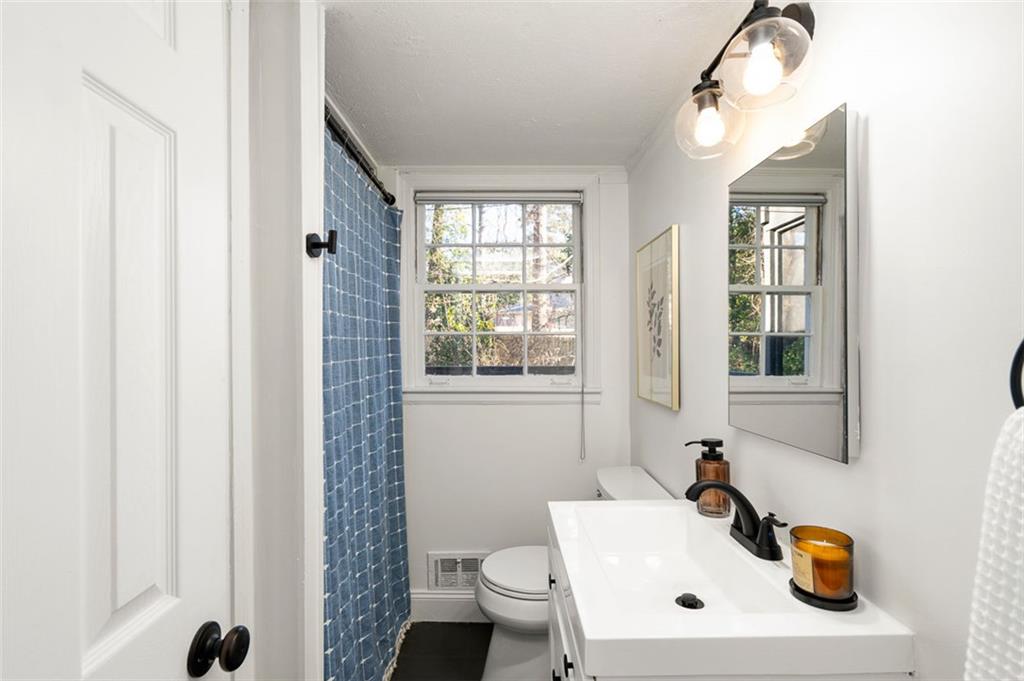 3059 Trafalgar Way Atlanta, GA 30341 - Photo 17 of 52 a bathroom with a sink a toilet and a mirror