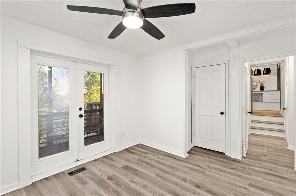 3059 Trafalgar Way Atlanta, GA 30341 - Photo 19 of 52 an empty room with wooden floor a ceiling fan and windows