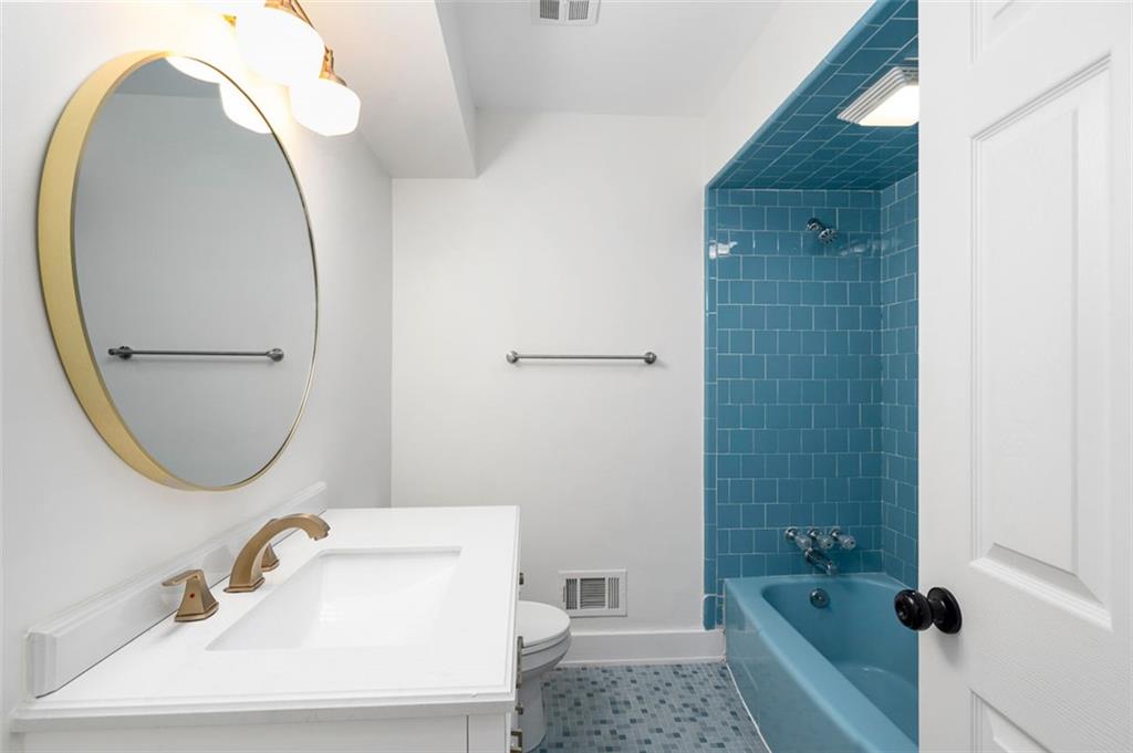 3059 Trafalgar Way Atlanta, GA 30341 - Photo 27 of 52 a bathroom with a sink a toilet and a mirror