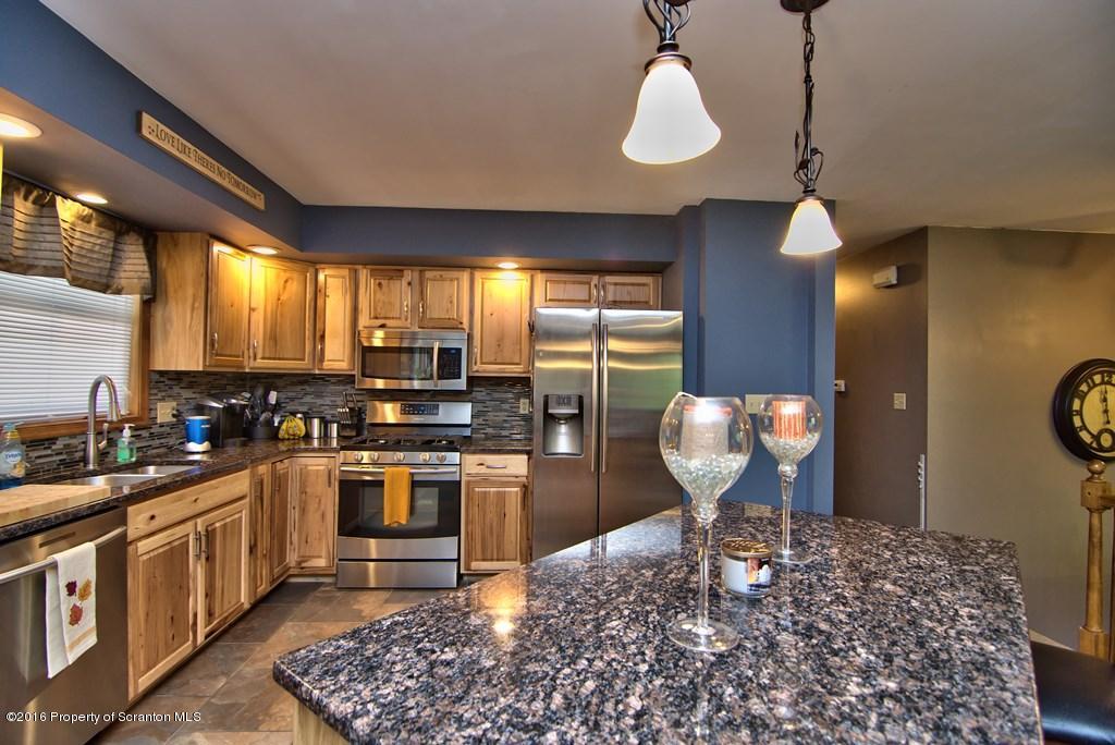 211 Spring Run Lane Moscow, PA 18444 - Photo 4 of 65 a kitchen with stainless steel appliances granite countertop a sink stove and refrigerator