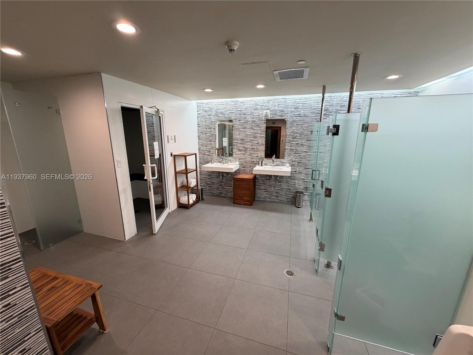 400 Alton Road, Unit LPH3007 Miami Beach, FL 33139 - Photo 37 of 51 a bathroom with a shower and a sink