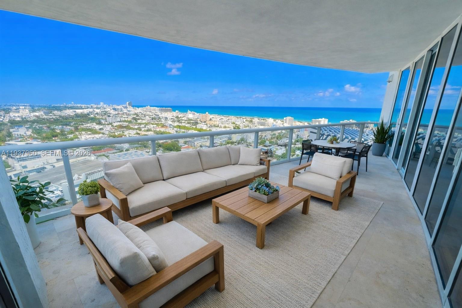 400 Alton Road, Unit LPH3007 Miami Beach, FL 33139 - Photo 4 of 51 a terrace with couches and a coffee table