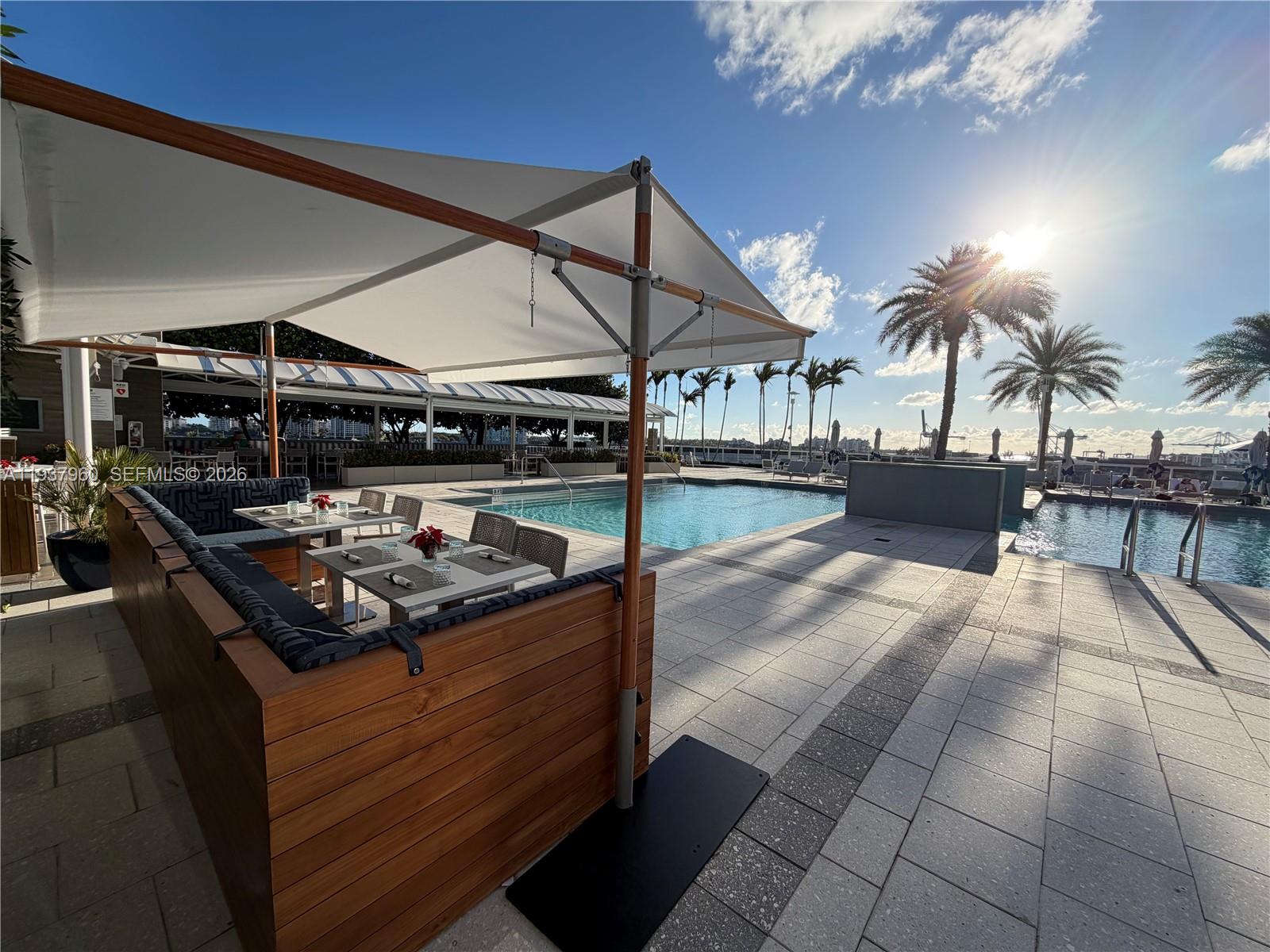 400 Alton Road, Unit LPH3007 Miami Beach, FL 33139 - Photo 49 of 51 a kitchen with a stove and a table