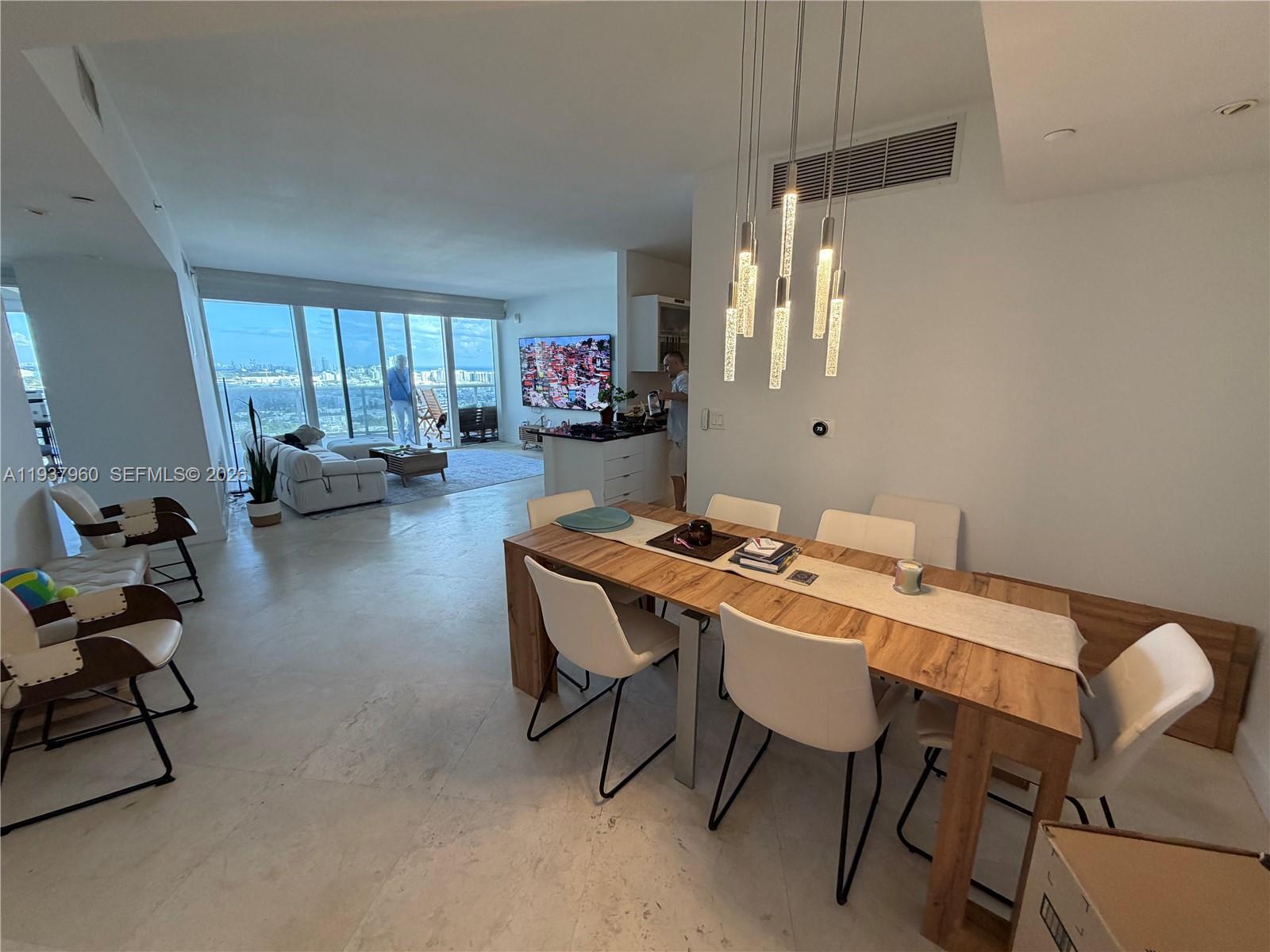 400 Alton Road, Unit LPH3007 Miami Beach, FL 33139 - Photo 9 of 51 a dining room with a table and chairs