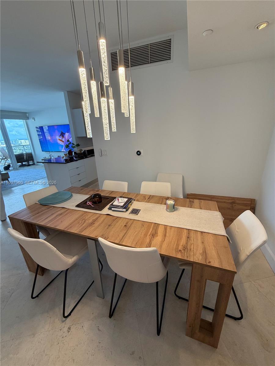 400 Alton Road, Unit LPH3007 Miami Beach, FL 33139 - Photo 10 of 51 a view of a dining room with furniture and a chandelier