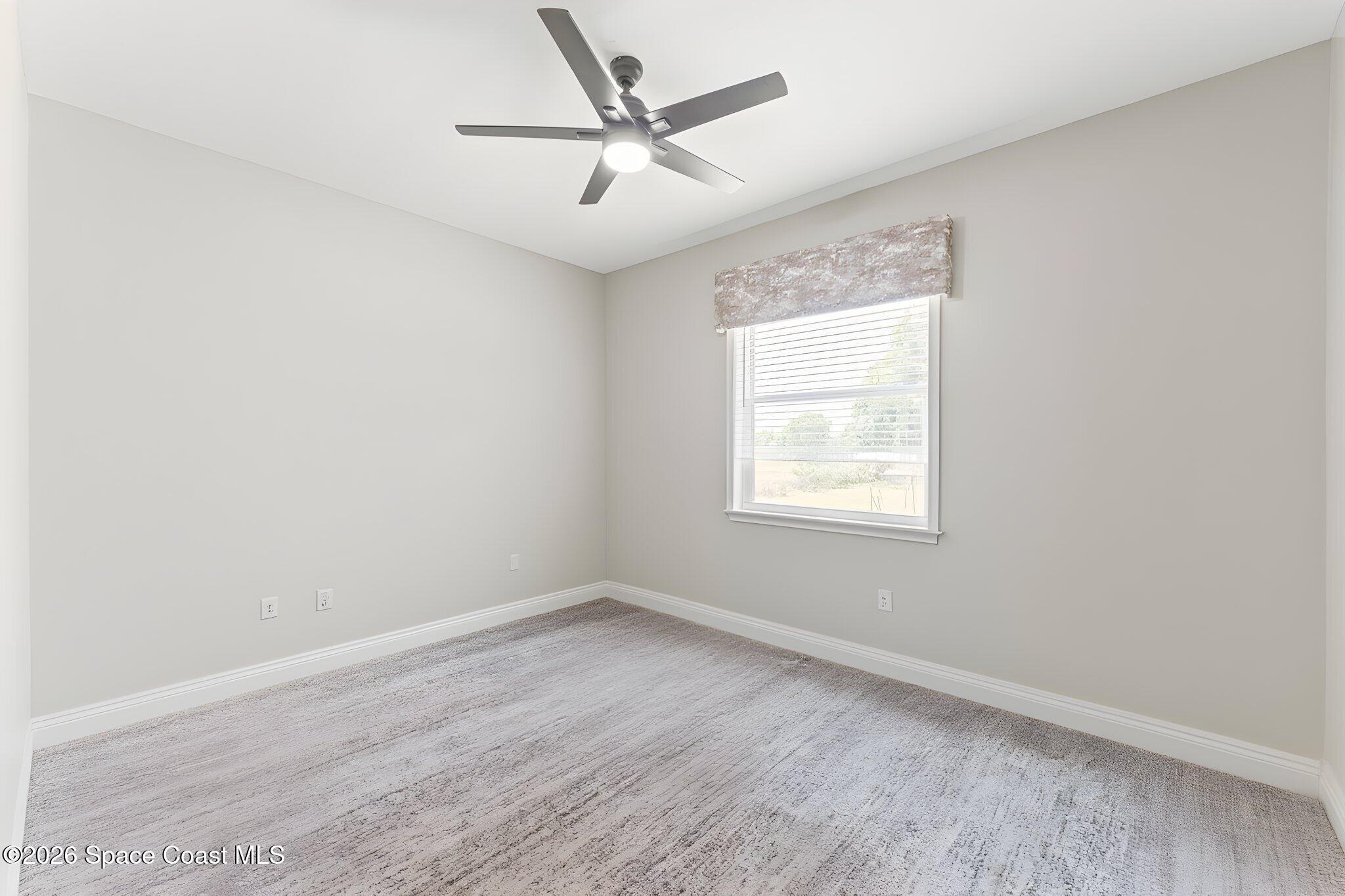 1740 Ford Road Mims, FL 32754 - Photo 30 of 43 an empty room with a window and a ceiling fan