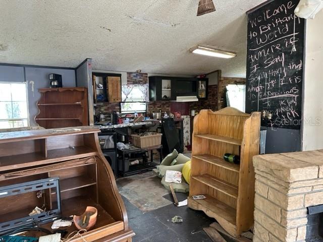 10207 East Pike Drive Inverness, FL 34450 - Photo 5 of 13 a kitchen with a refrigerator and a stove top oven