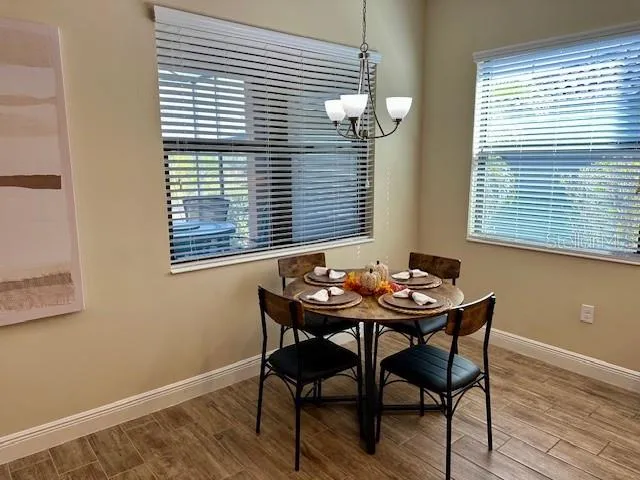 a view of a room that has a table and chairs in it