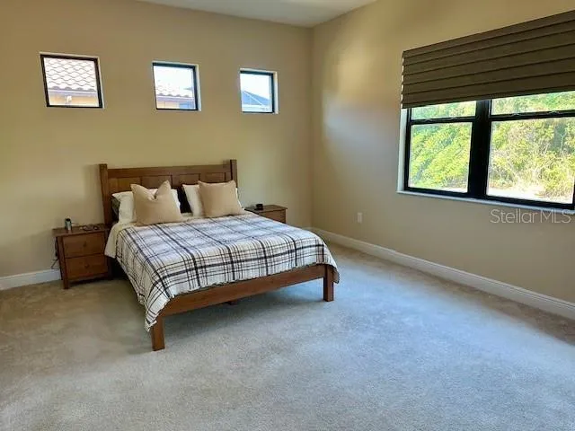 a bed sitting in a bedroom next to a window