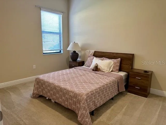 a bedroom with a bed and window