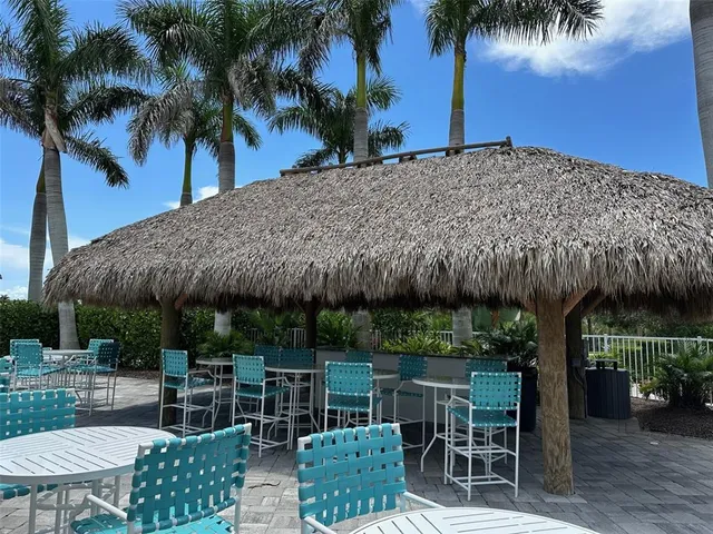a patio table with chairs and potted plants