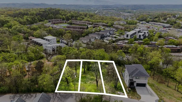 an aerial view of house with a yard