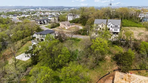 an aerial view of residential house with green space