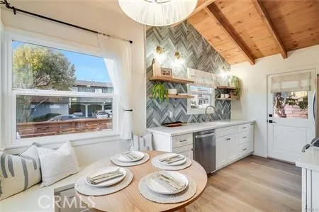 a dining room with furniture a window and wooden floor