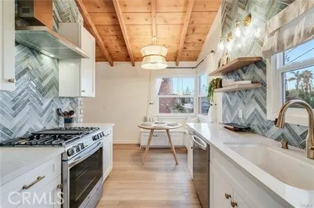a kitchen with stainless steel appliances granite countertop a sink stove and cabinets