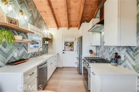 a kitchen with stainless steel appliances granite countertop a stove and a sink