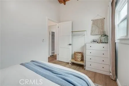 a bedroom with a bed and a mirror