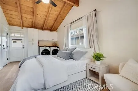 a bedroom with a large bed and a chandelier