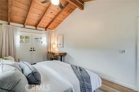 a bedroom with a bed a table and chair