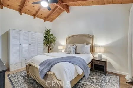 a bedroom with a bed and a potted plant