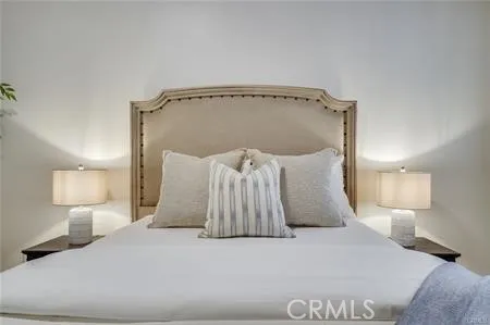 a large bed sitting in a bedroom and lamp