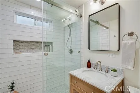 a bathroom with a sink vanity and a mirror