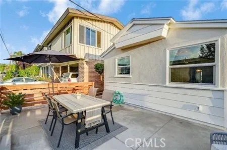 a view of a house with backyard and sitting area