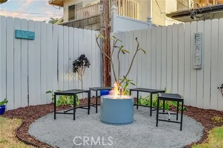 a backyard of a house with table and chairs