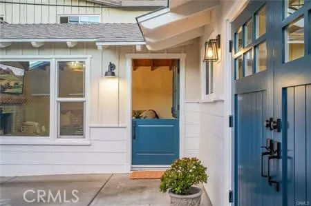 a view of a brick house with a potted plant and a window