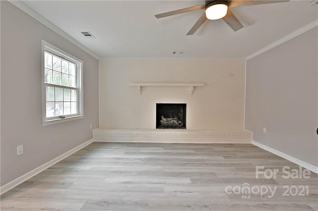 2441 State Rd S-29-305 Lancaster, SC 29720 - Photo 4 of 29 a view of an empty room with wooden floor and a window
