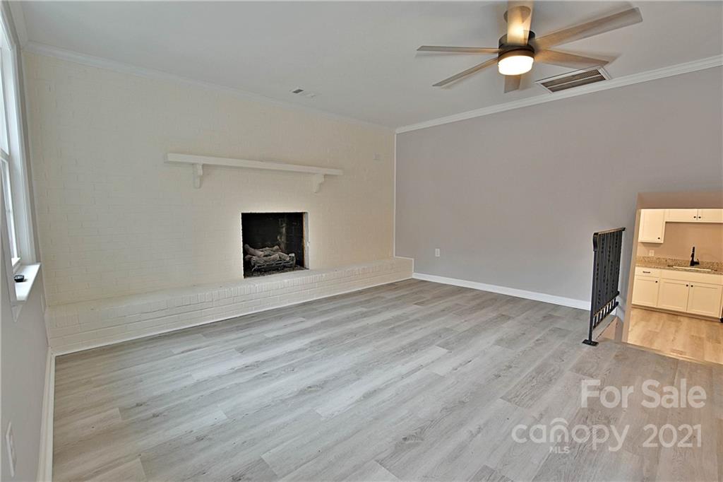 2441 State Rd S-29-305 Lancaster, SC 29720 - Photo 5 of 29 a view of empty room with wooden floor and fan