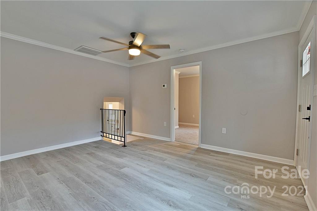 2441 State Rd S-29-305 Lancaster, SC 29720 - Photo 6 of 29 an empty room with wooden floor fan and windows