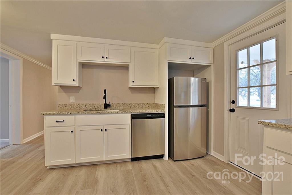 2441 State Rd S-29-305 Lancaster, SC 29720 - Photo 9 of 29 a kitchen with granite countertop a refrigerator and a sink