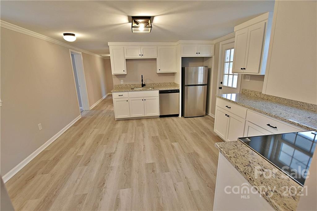 2441 State Rd S-29-305 Lancaster, SC 29720 - Photo 10 of 29 a large kitchen with a lot of white cabinets and stainless steel appliances
