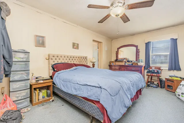 a bedroom with bed and a chandelier