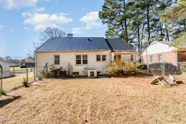 a view of a white house with a yard covered in snow