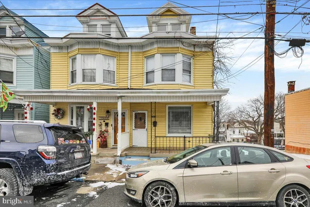 a front view of a house with parking space