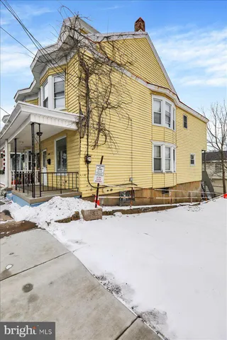 a front view of a house with yard and road