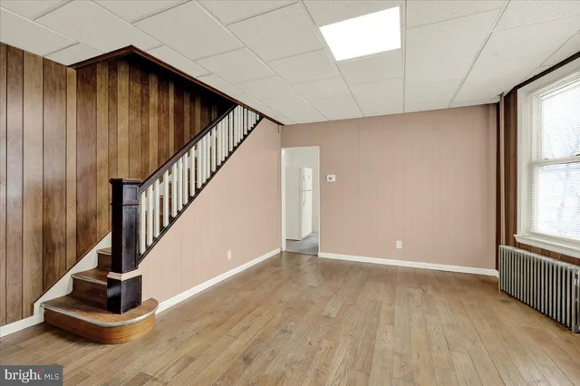 a view of an entryway with wooden floor and door