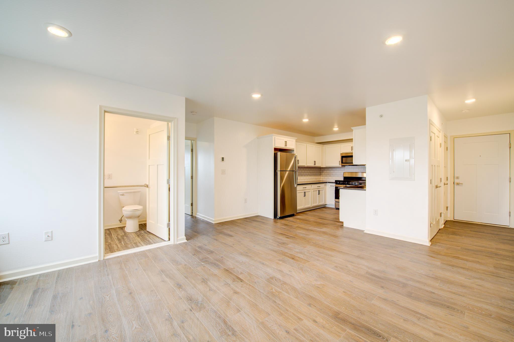 6649 Ridge Avenue, Unit B406 Philadelphia, PA 19128 - Photo 2 of 8 a view of kitchen with refrigerator and wooden floor