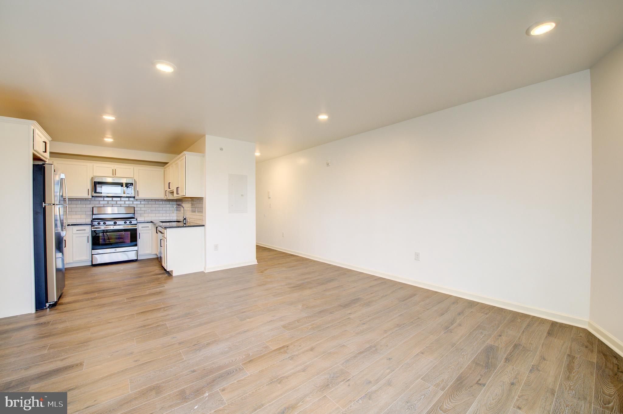 6649 Ridge Avenue, Unit B406 Philadelphia, PA 19128 - Photo 4 of 8 a view of kitchen with wooden floor