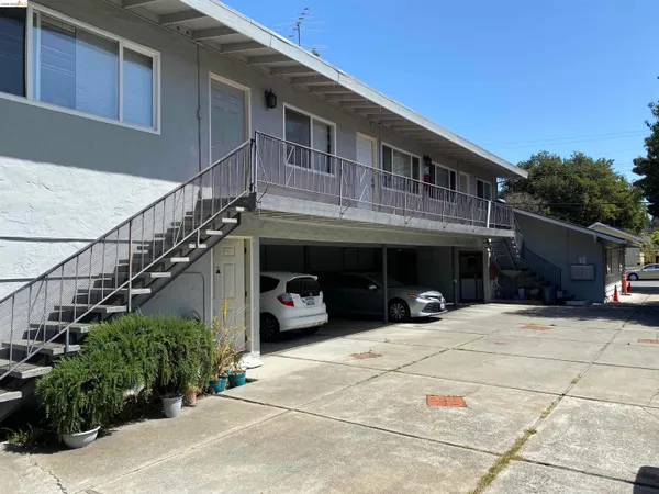 a view of a building with car parked