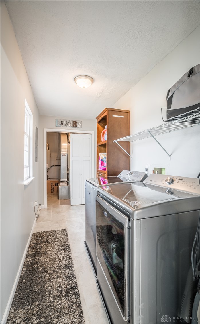 1442 Langdon Road Sidney, OH 45365 - Photo 19 of 34 This dedicated laundry area offers practicality and ample storage for daily chores.
