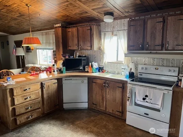 a kitchen with sink cabinets and window