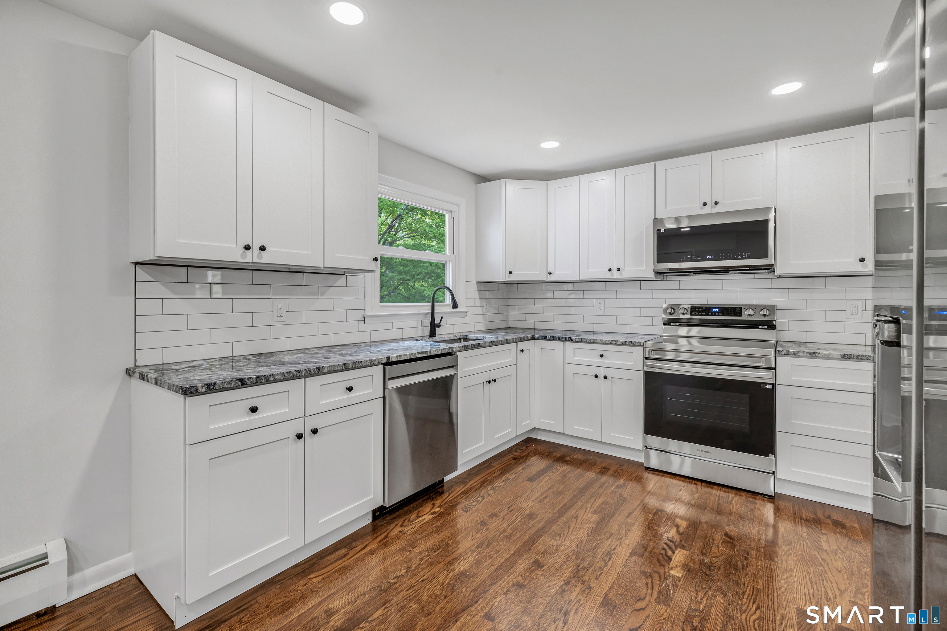 7 Longview Road Newtown, CT 06482 - Photo 12 of 40 a kitchen with granite countertop white cabinets and appliances