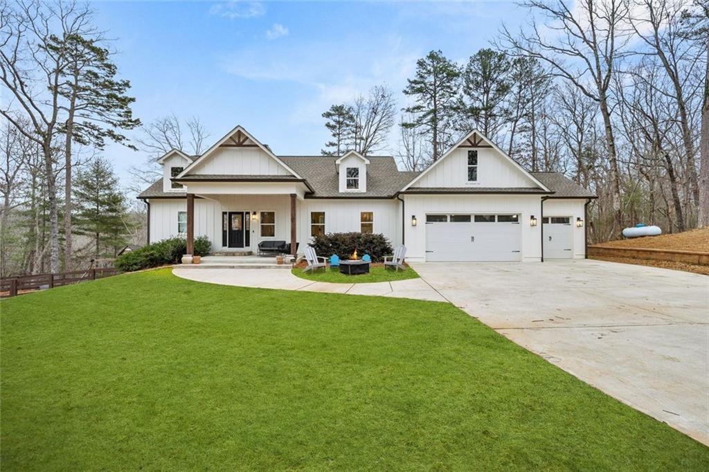 114 Choctaw Ridge North Dahlonega, GA 30533 - Photo 1 of 1 a front view of a house with a garden and trees