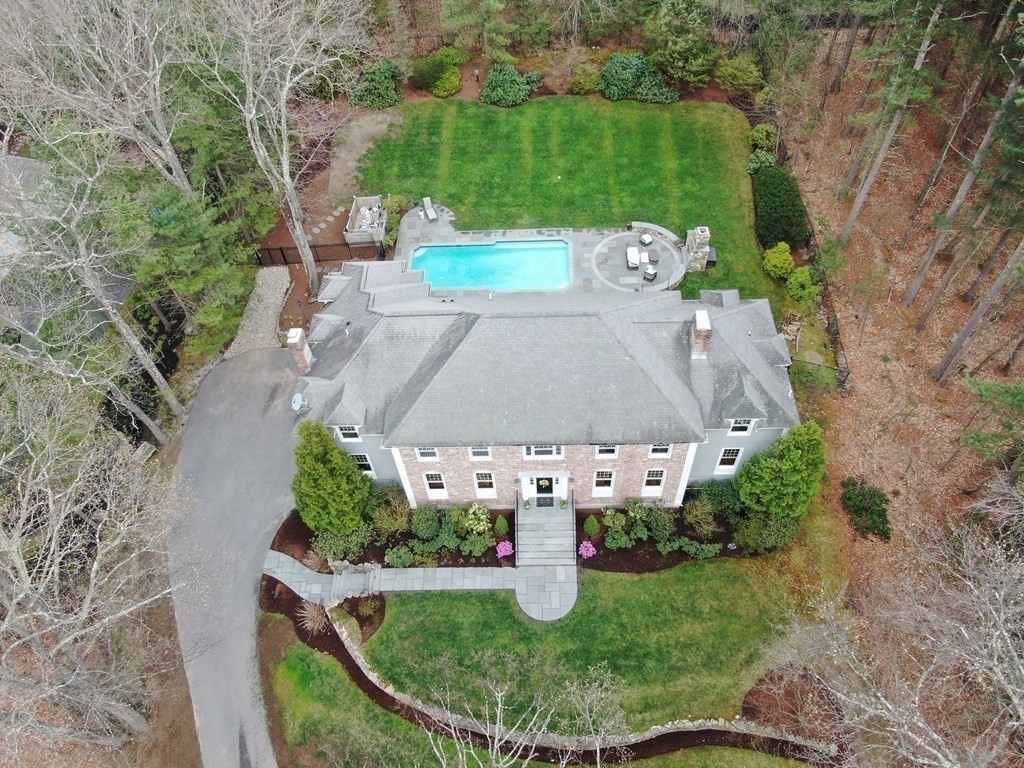 an aerial view of a house with garden space and street view