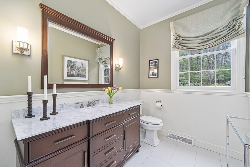 90 Ruddock Road Sudbury, MA 01776 - Photo 20 of 41 a bathroom with a granite countertop sink mirror and toilet