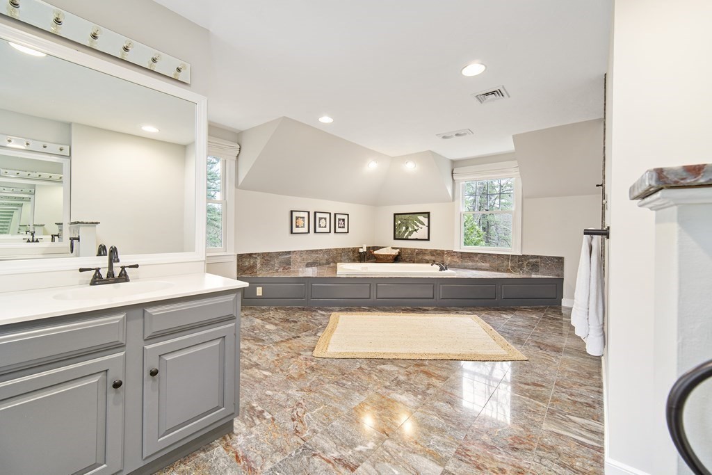 90 Ruddock Road Sudbury, MA 01776 - Photo 22 of 41 a spacious bathroom with a tub sink and mirror